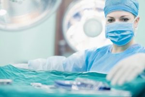 Doctor reaching for surgical tools in hospital operating room